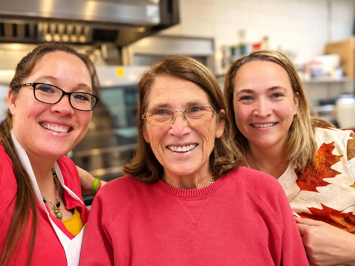 Emily Raffel with her daughters Nicki and Maggie in the kitchen