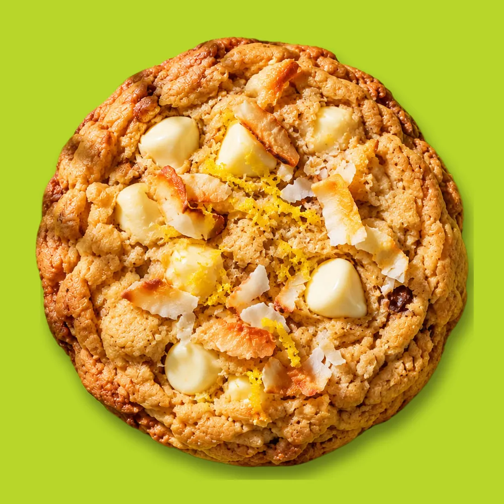 Lemon zest cookie topped with white chocolate chips, toasted coconut and fresh lemon zest