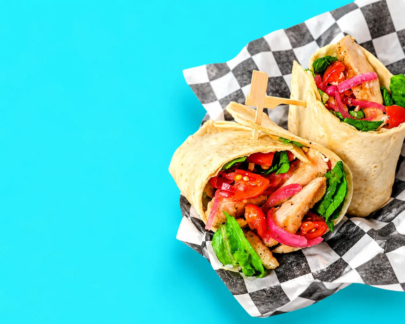 Grilled chicken wrap with spinach, tomatoes and pickled red onion